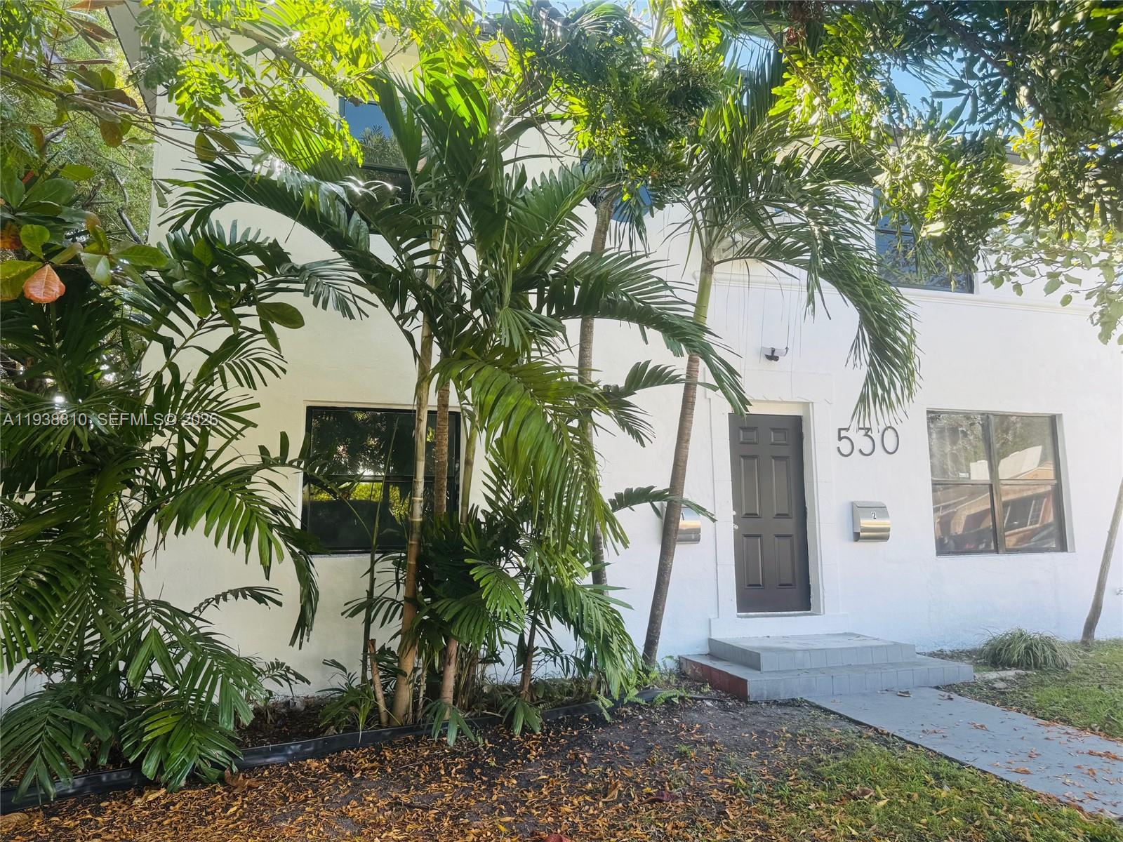 530 Northeast 71st Street, Unit 2 Miami, FL 33138 - Photo 9 of 22 a front view of a house with a tree