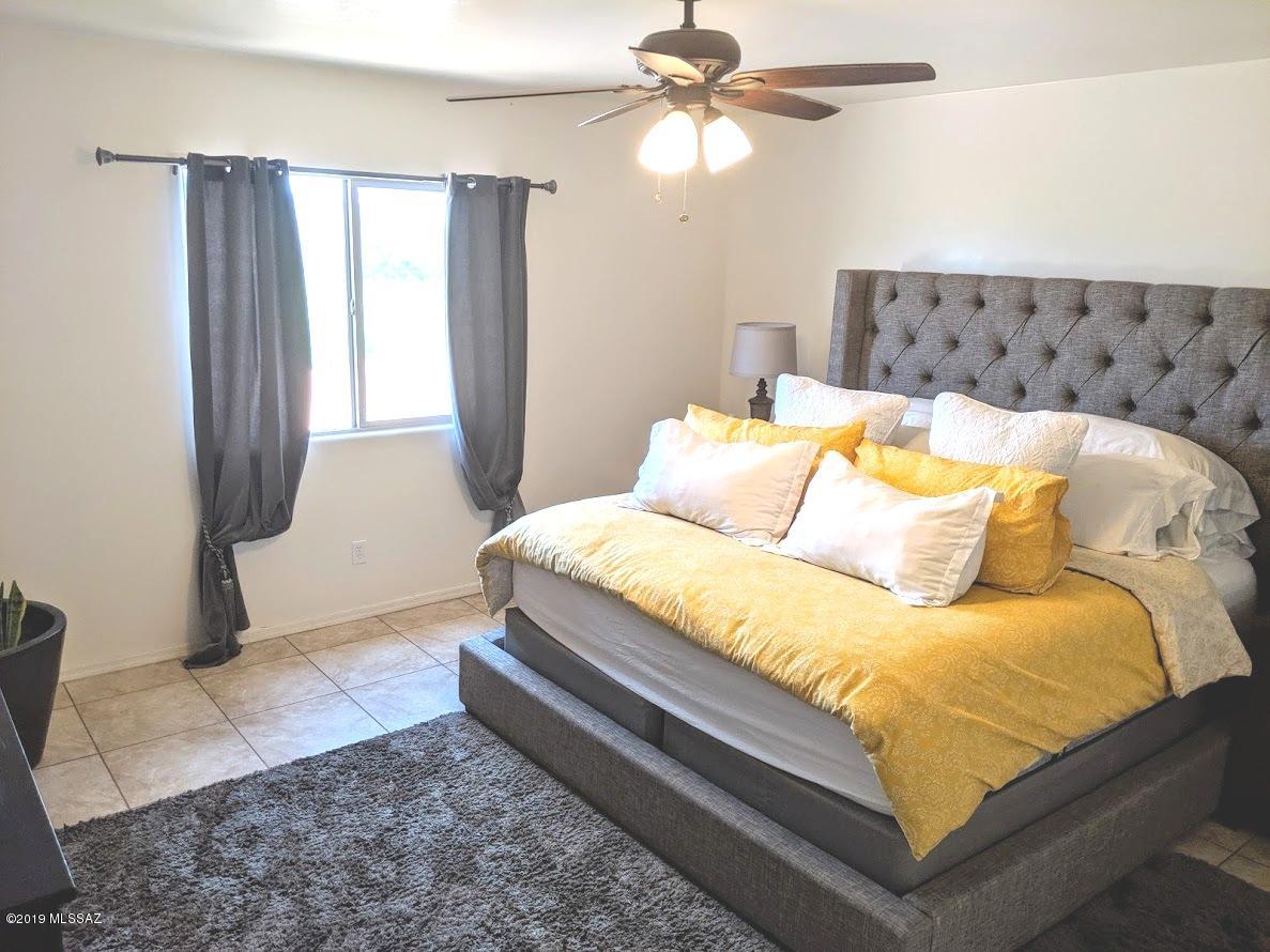 364 Annette Court Rio Rico, AZ 85648 - Photo 13 of 23 a bedroom with a bed and window