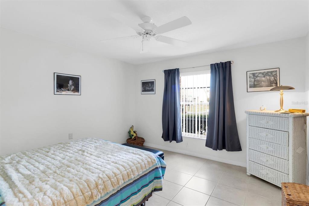 9052 Arundle Place New Port Richey, FL 34655 - Photo 18 of 57 a bedroom with a bed and a window