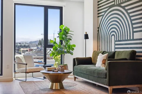 a living room with furniture and a potted plant