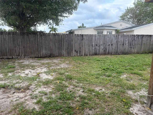 a view of outdoor space with wooden fence