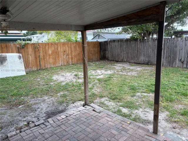 a view of a backyard with small cabin