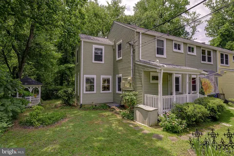 a view of a house with a yard and plants