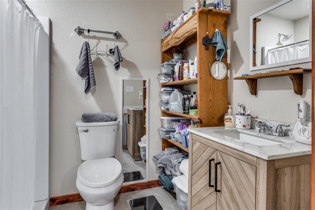 218 Homestead Court Lipan, TX 76462 - Photo 10 of 17 a bathroom with a sink toilet and shower