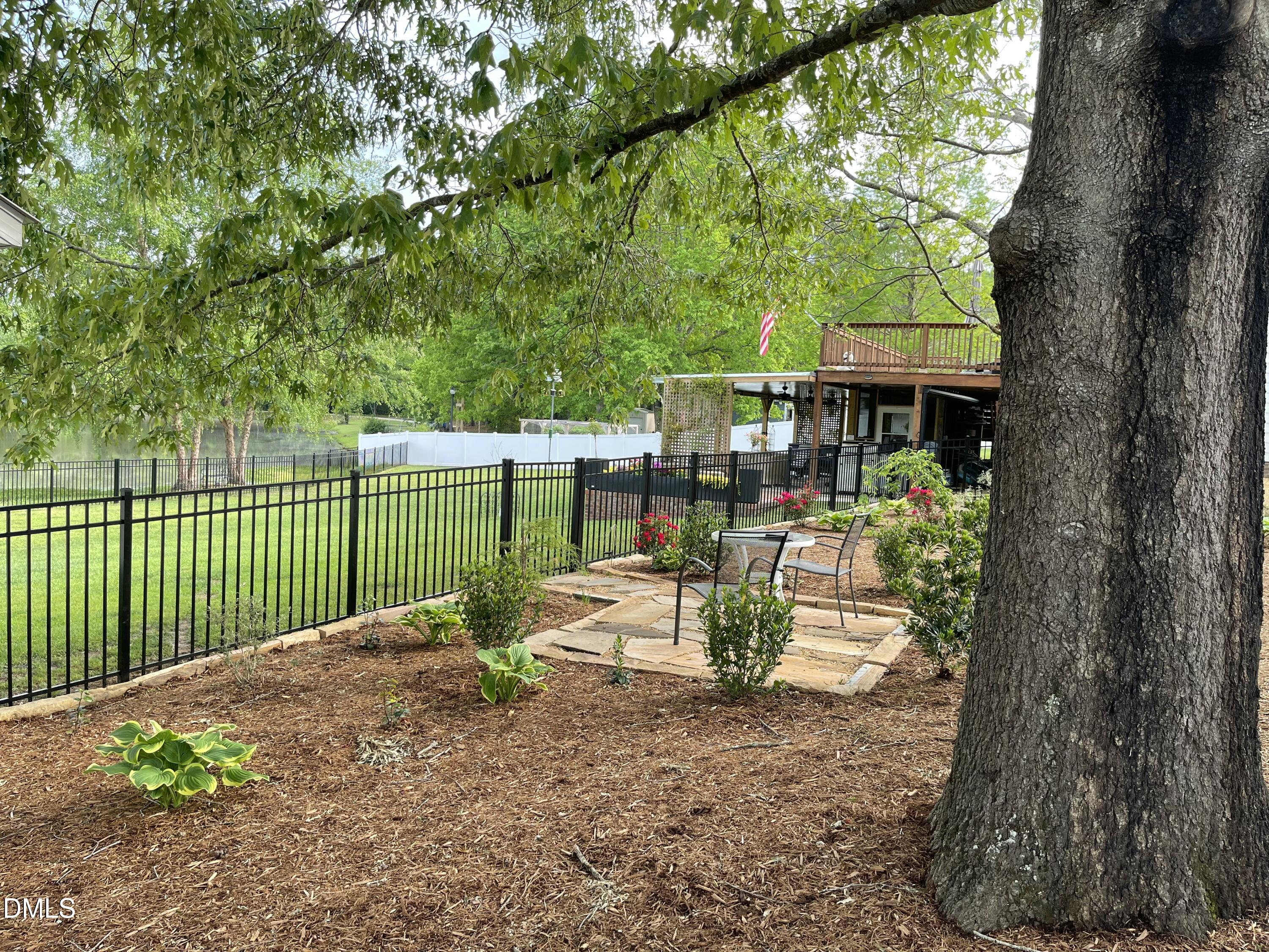 735 Cross Link Drive Angier, NC 27501 - Photo 56 of 73 a view of a chair and tables in the backyard