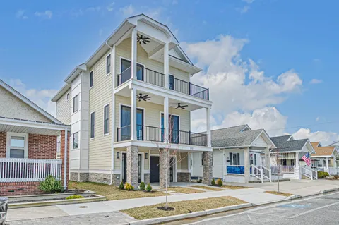 a front view of a residential apartment building with a yard