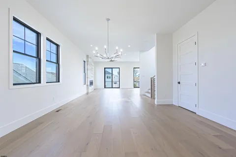 wooden floor fireplace and windows in an empty room