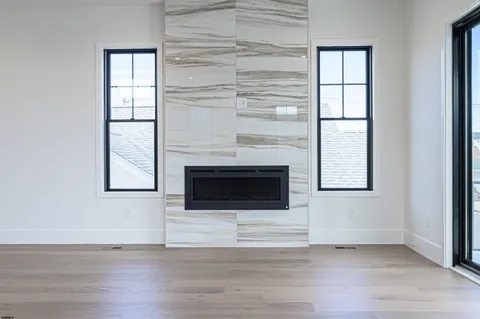 a living room with a fireplace and a window