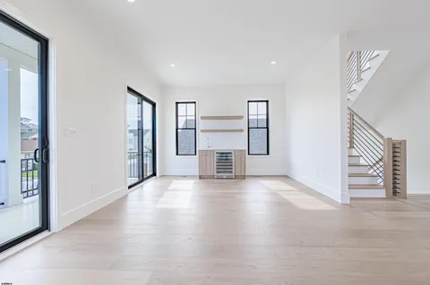 a view of kitchen and hall with wooden floor