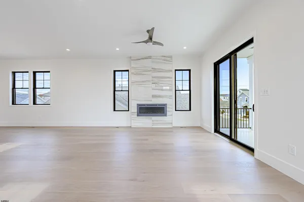 a view of a room with wooden floor and windows