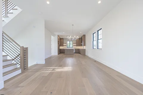 a kitchen with stainless steel appliances granite countertop a sink a stove and a refrigerator