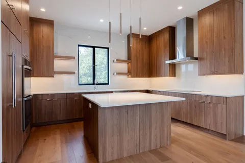 a kitchen with stainless steel appliances a sink and a refrigerator
