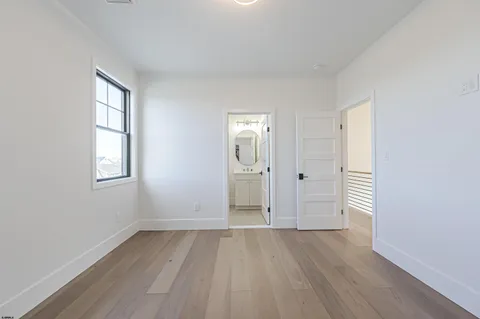 an empty room with windows and closet