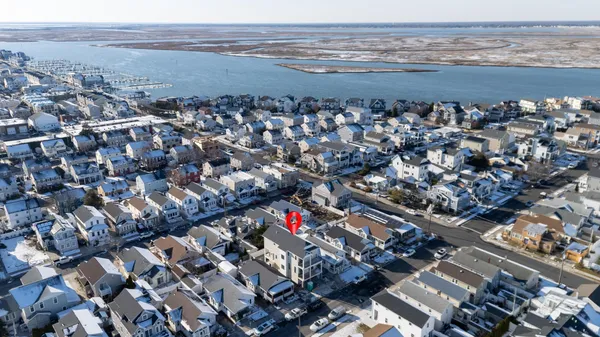 an aerial view of residential houses with city view