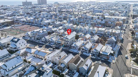an aerial view of residential houses with city view
