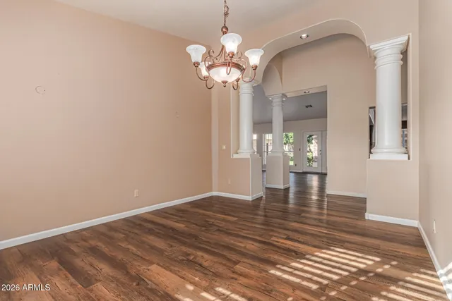 a view of a room with a ceiling fan a kitchen and a window