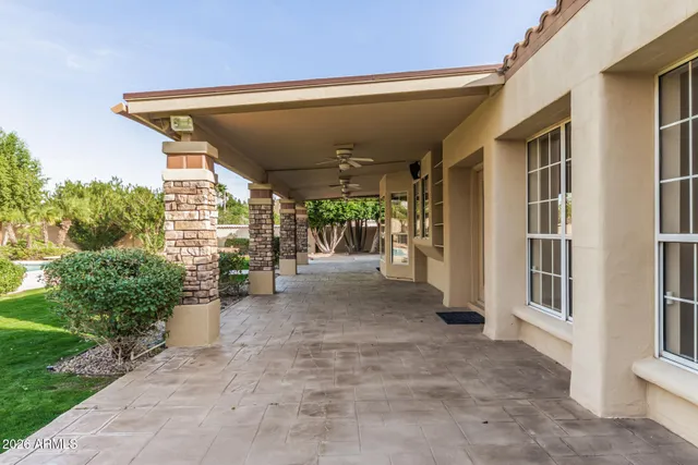 an aerial view of residential houses with outdoor space and trees