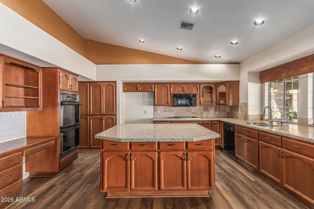 an aerial view of a house with a mountain