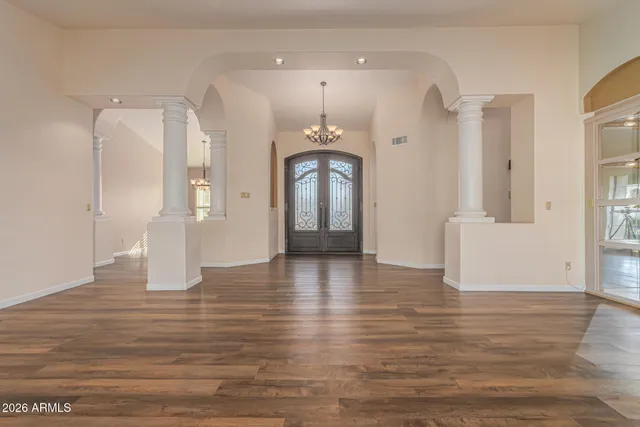 a view of an empty room with a fireplace and a window