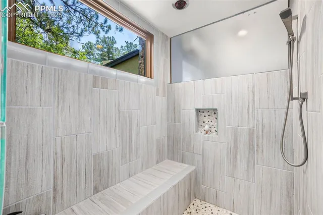 a bathroom with a shower curtain and a large window