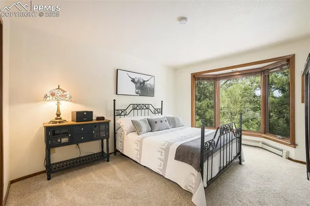 a bedroom with a bed and a large window