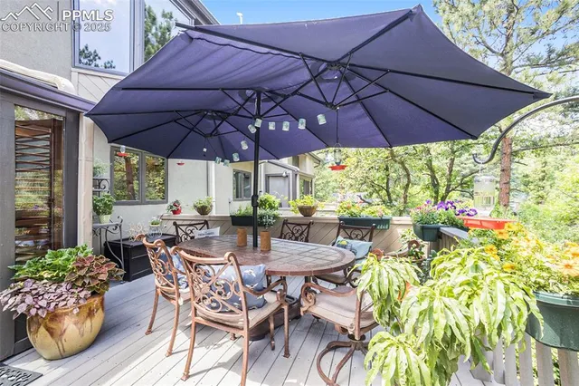 a view of a patio with a table and chairs under an umbrella