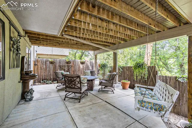 a patio with patio couch and chairs