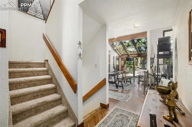 a view of entryway and hall with wooden floor