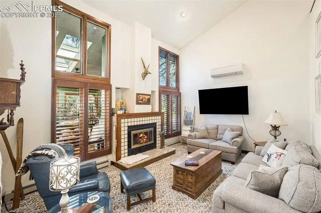 a living room with furniture a flat screen tv and a fireplace