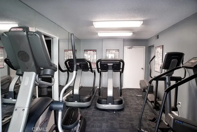 a room with gym equipment and mirror
