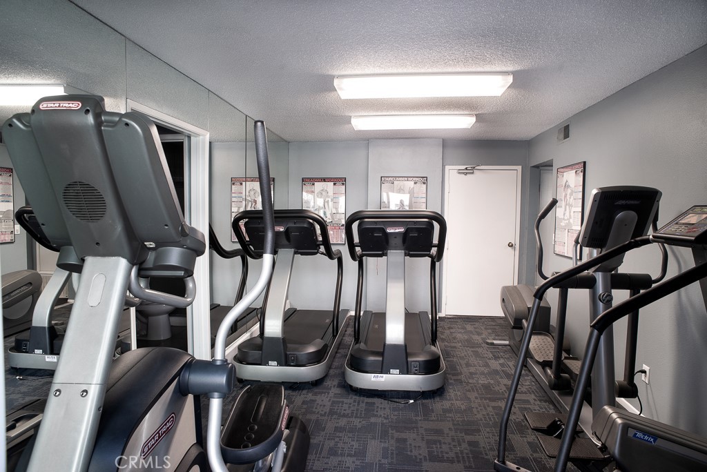 1940 Highland Avenue, Unit 10 Los Angeles, CA 90068 - Photo 18 of 22 a room with gym equipment and mirror
