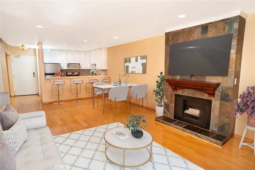 1940 Highland Avenue, Unit 10 Los Angeles, CA 90068 - Photo 7 of 22 a living room with stainless steel appliances furniture a fireplace and a flat screen tv