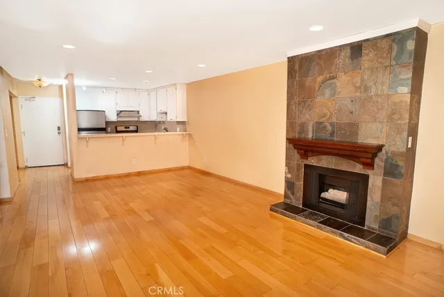 a kitchen with a refrigerator and a fireplace