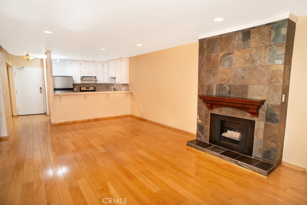 1940 Highland Avenue, Unit 10 Los Angeles, CA 90068 - Photo 8 of 22 a kitchen with a refrigerator and a fireplace