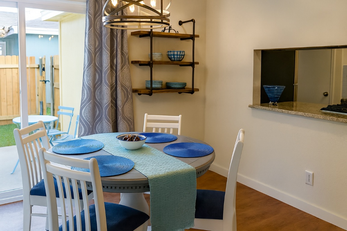 508 Country Aire Drive, Unit B Round Rock, TX 78664 - Photo 2 of 4 Dining space featuring wood finished floors and a chandelier