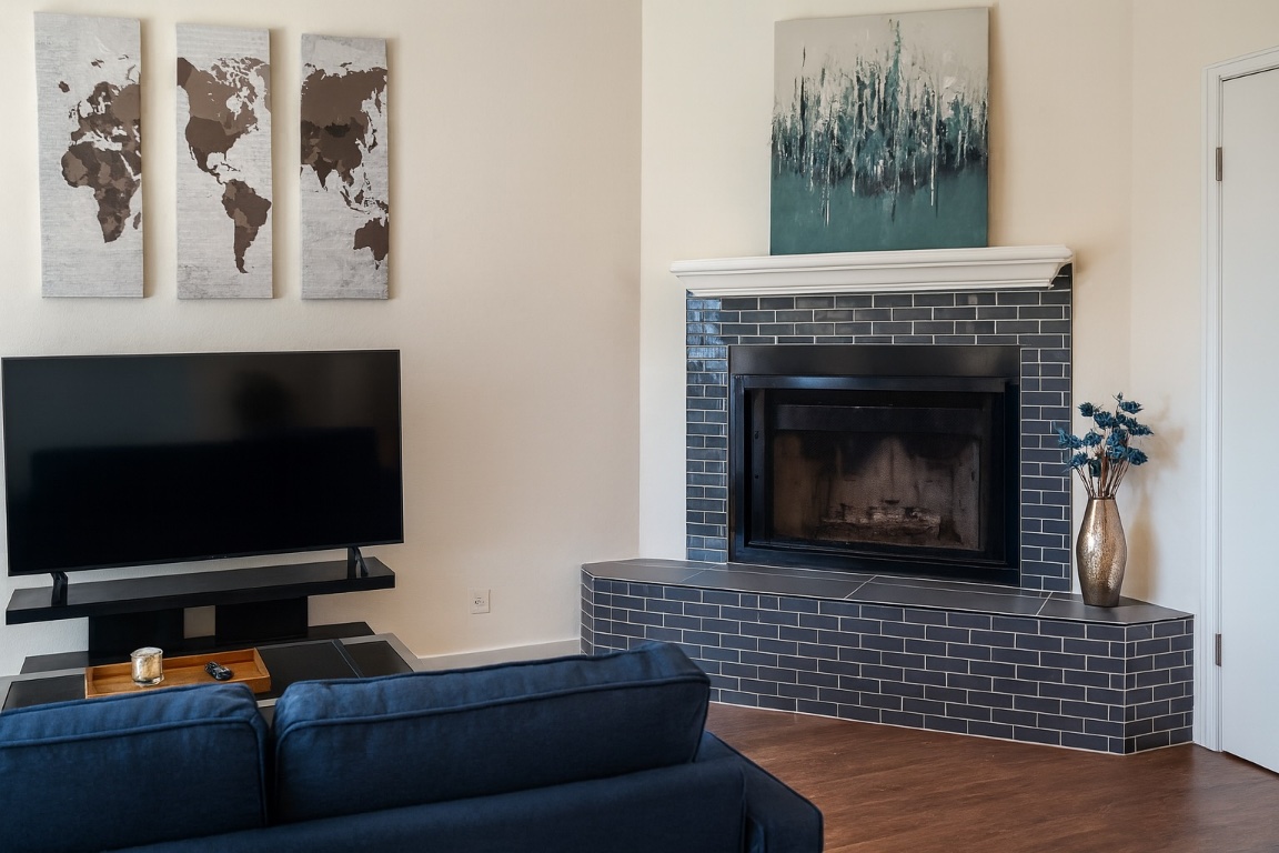 508 Country Aire Drive, Unit B Round Rock, TX 78664 - Photo 3 of 4 Living room with a tiled fireplace and wood finished floors