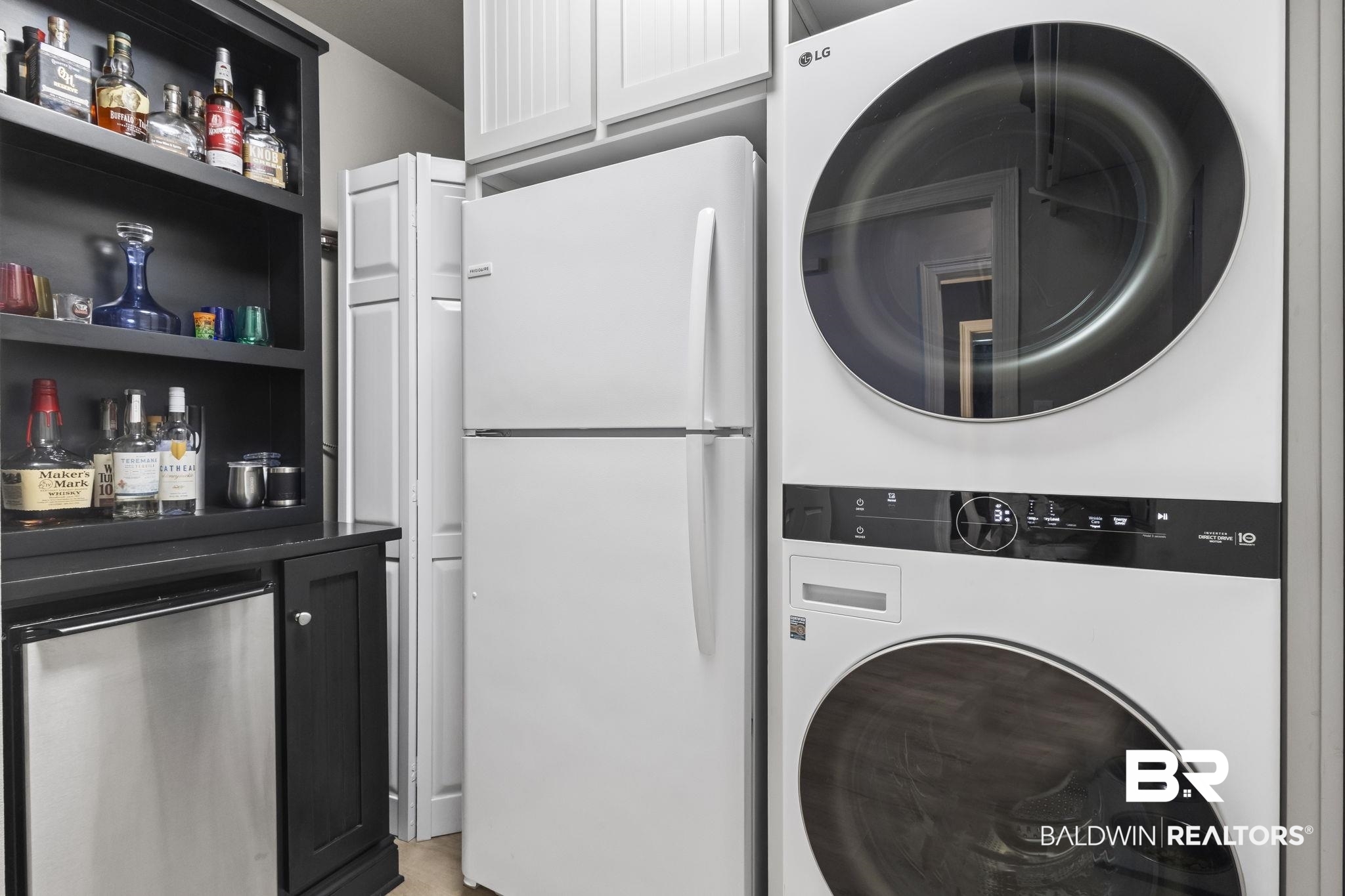 28250 Canal Road, Unit 403 Orange Beach, AL 36561 - Photo 22 of 54 Laundry room featuring stacked washer and clothes dryer and a bar