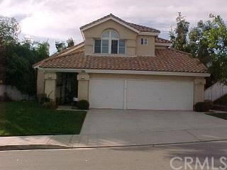 6956 Rockspring Lane Highland, CA 92346 - Photo 1 of 1 a front view of a house with a garden
