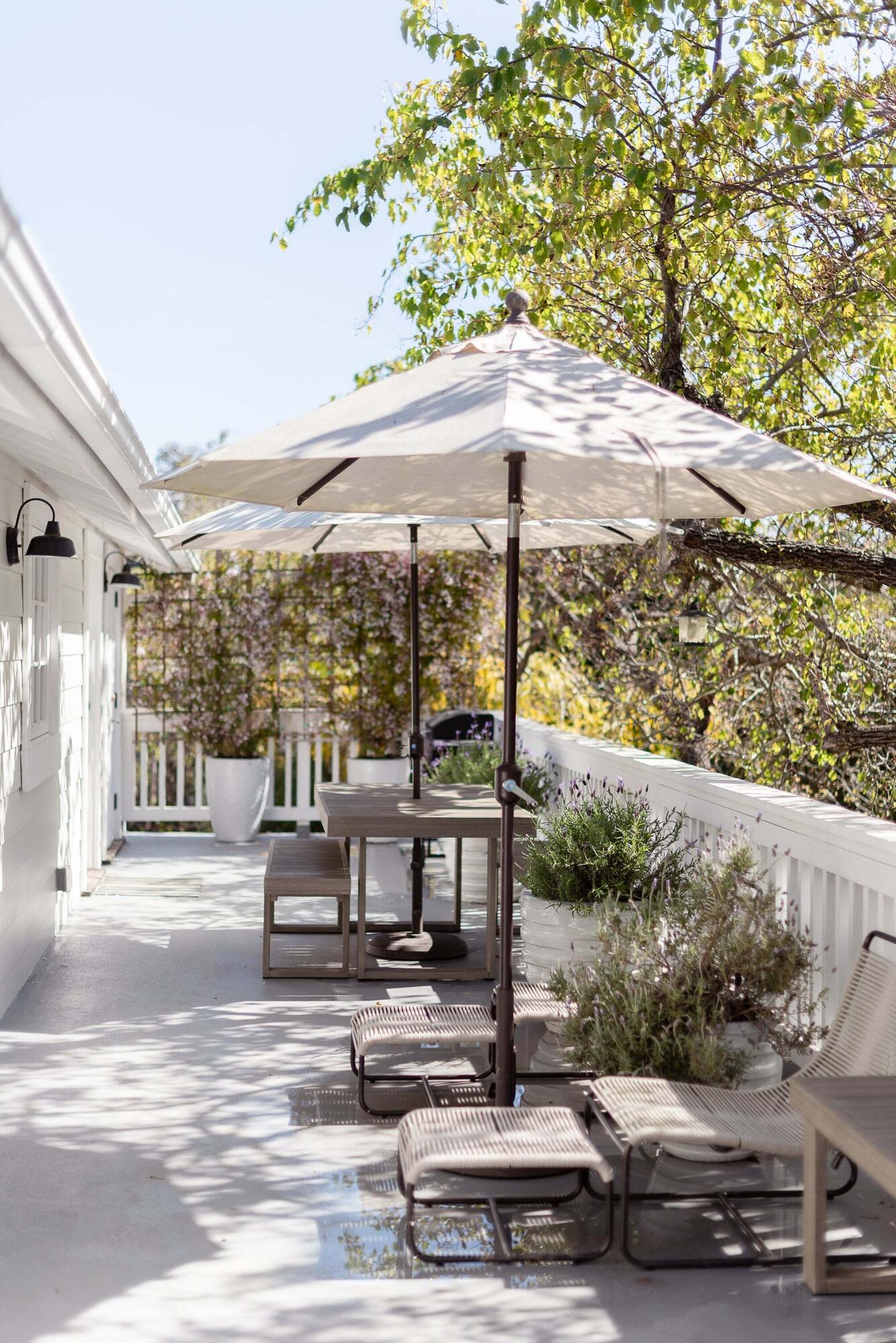 1355 Danielson Road Montecito, CA 93108 - Photo 16 of 25 a view of a patio with table and chairs under an umbrella with a large tree