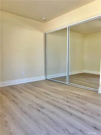wooden floor in an empty room with a glass door