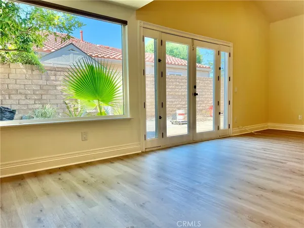 an empty room with wooden floor and a window