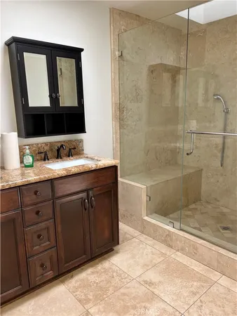 a bathroom with a tub sink and mirror