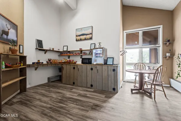 a view of living room with furniture and wooden floor