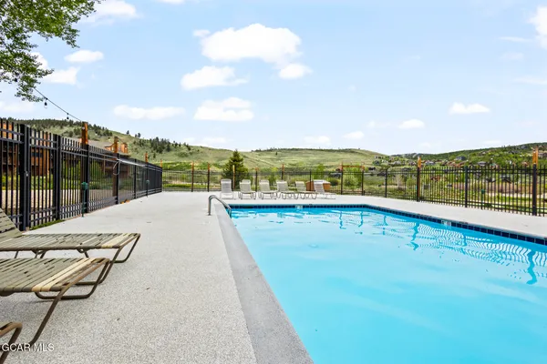 a view of swimming pool with a garden in the background