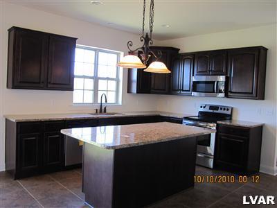 212 East Dell Road Bath, PA 18014 - Photo 16 of 24 a kitchen with stainless steel appliances granite countertop a sink stove and microwave