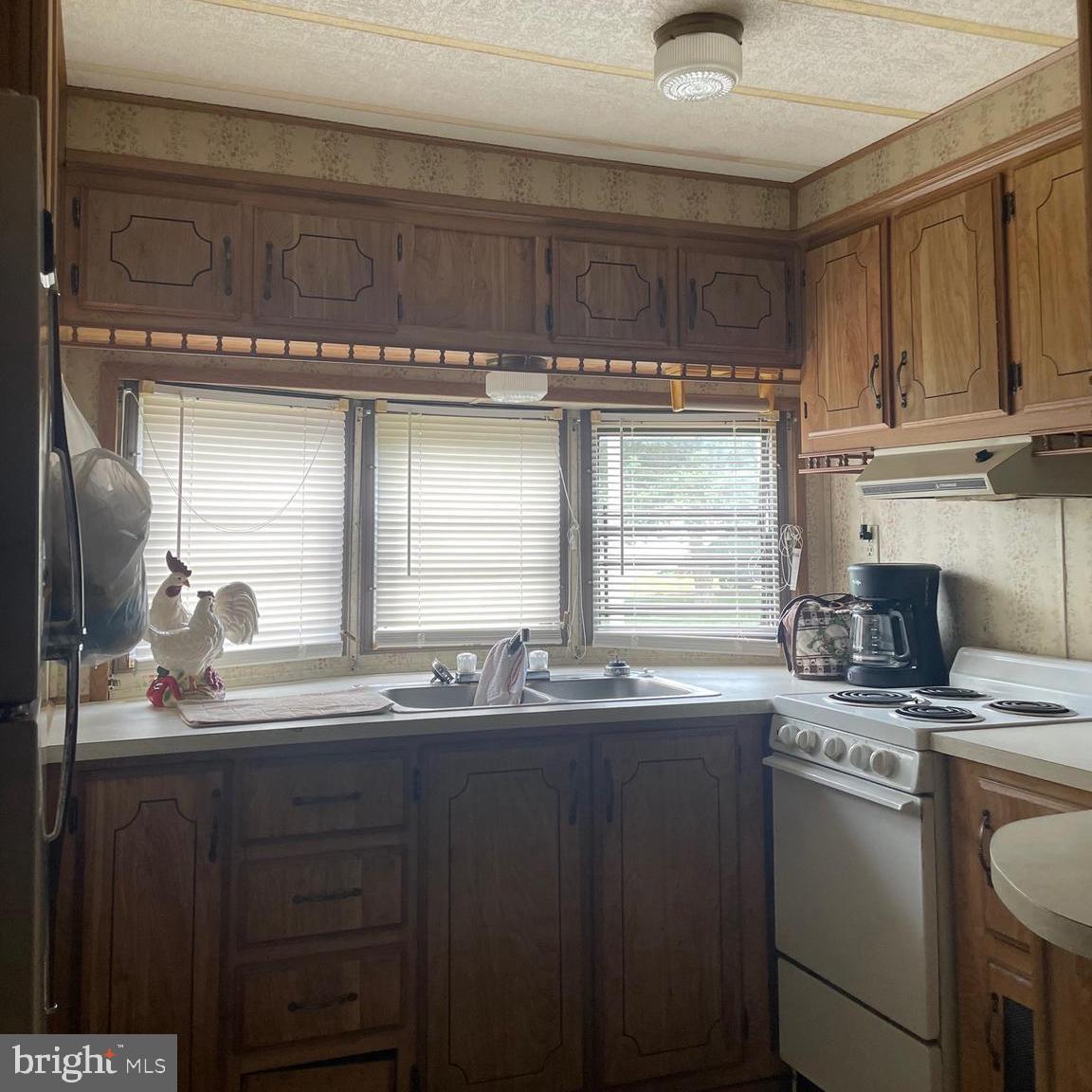 1 Ranger Road Falling Waters, WV 25419 - Photo 4 of 20 a kitchen with a sink a stove cabinets and a window