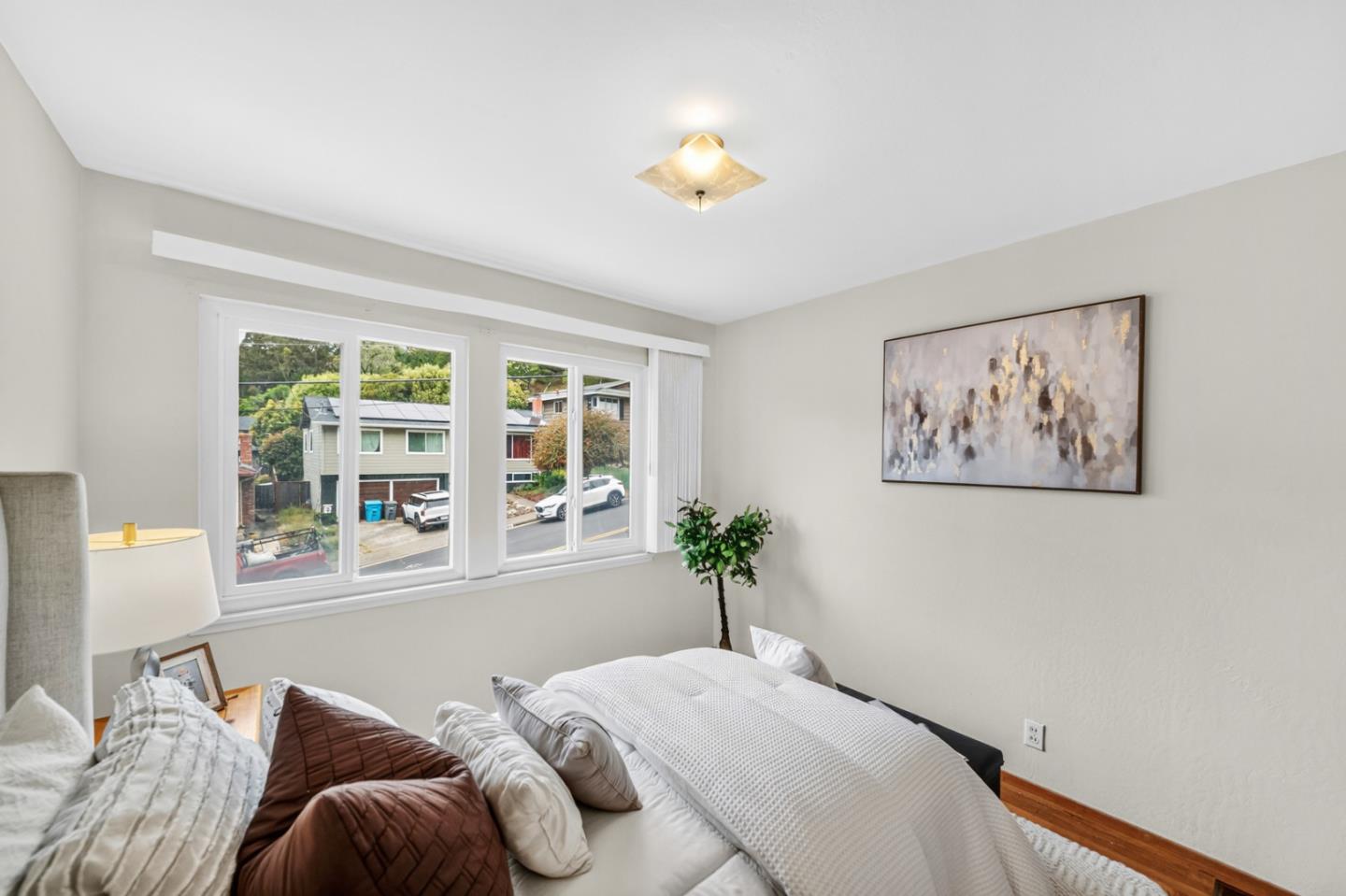 1287 Lerida Way Pacifica, CA 94044 - Photo 35 of 52 a bedroom with a bed and a painting on the wall