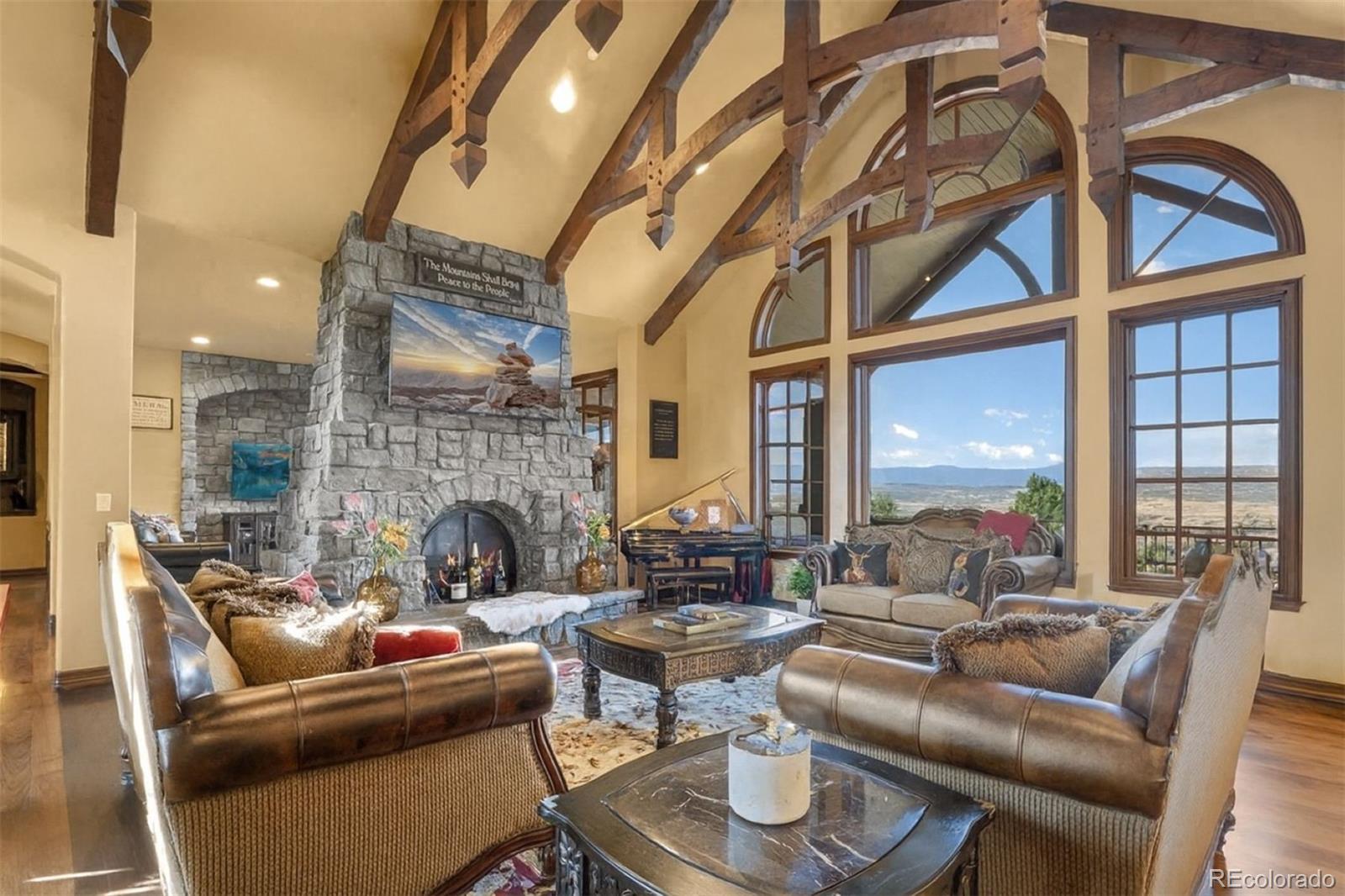 3440 Medallion Road Castle Rock, CO 80104 - Photo 11 of 50 a living room with fireplace furniture and a large window