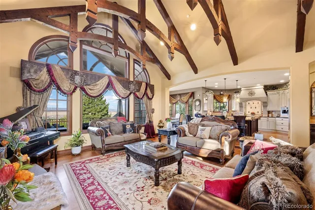 a living room with furniture and a floor to ceiling window