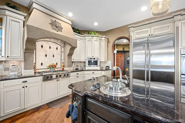 a kitchen with sink refrigerator and cabinets